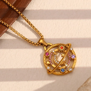 Macro shot of 18K gold plated compass pendant necklace with colorful star and moon gems