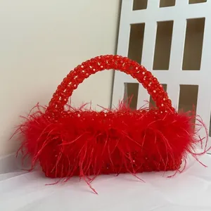 Red beaded evening handbag with elegant ostrich feather trim and pearl-like handle
