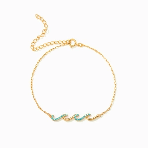Bracelet élégant en argent s925 doré avec design ondulé et pierres turquoise bleues