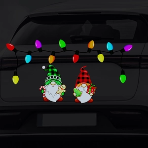 Close-up of Christmas gnomes and colorful light bulb magnetic stickers on a car rear window