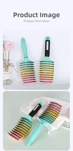 Close-up of rainbow gradient vented hairbrush with black bristles and ergonomic handle
