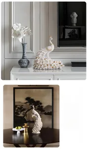 Detail of white peacock statues with gold accents in modern living room setting