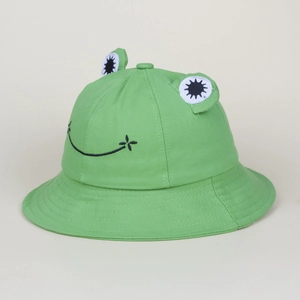 Detail of cute green frog bucket hat with 3D eyes and black embroidered smile