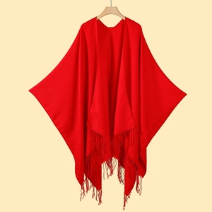 Classic red knitted tassel shawl cape for women, versatile pashmina style on wooden hanger