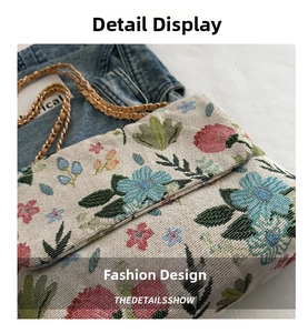 Close-up of floral jacquard fabric texture and gold chain strap on the crossbody bag