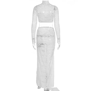 Detailed back view of white lace crop top and maxi skirt set with delicate floral patterns