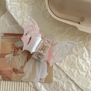 Detail view of marble pattern bat wing hair claw clip on vintage background