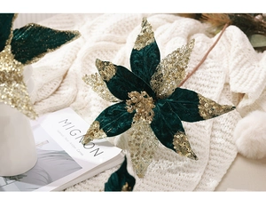 Close-up of green velvet poinsettia flower with golden sequins for Christmas decor