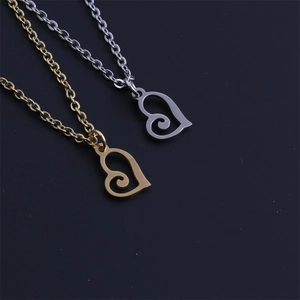 Detailed view of gold and silver heart necklaces with spiral hollow design