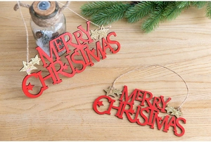 Detail of red wooden Merry Christmas hanging sign with gold glitter stars and jute rope