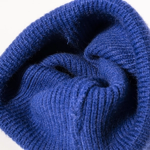Thick navy blue ribbed knit beanie hat for winter outdoor warmth with folded cuff texture