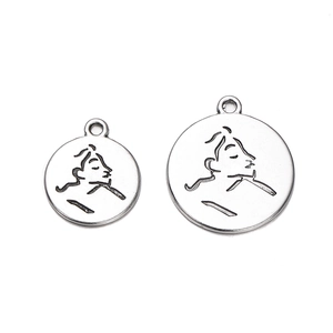 Detailed view of silver coin pendants with abstract face engravings for DIY jewelry