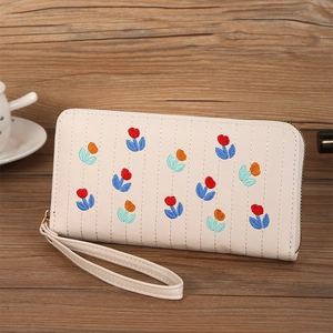 Detail of cream long zipper wallet with floral tulip embroidery and wristlet strap
