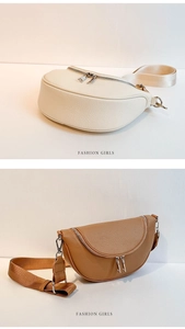 Detail view of crescent crossbody bags in cream and tan with lychee grain texture