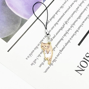 Cute enamel cat charm with cream brown stripes and gold plating on a phone lanyard