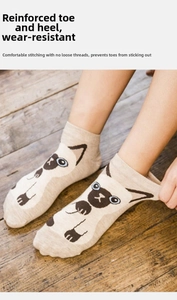 Detail of light beige cotton low-cut sock with Siamese cat print on wooden floor