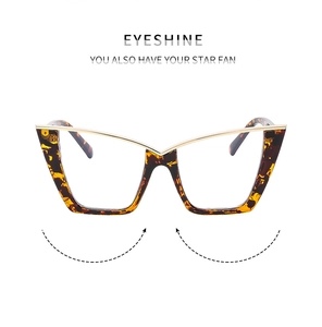 Detail of cat-eye frames featuring tortoiseshell patterns and elegant gold metal bridge