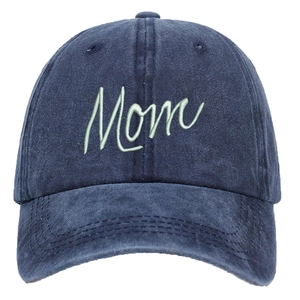 Detail of light green Mom script embroidery on a washed navy blue cotton baseball cap