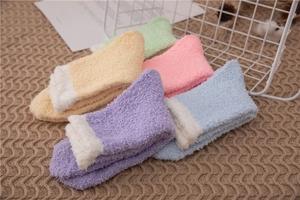 Detailed texture of thick coral fleece winter socks in soft macaron pastel colors