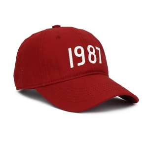 Detail view of the red cotton baseball cap with white 1987 number embroidery