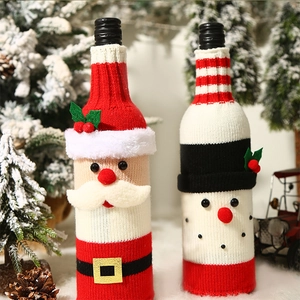 Detailed close-up of Santa and Snowman knitted wine bottle covers for Christmas decor
