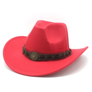 Detail of red wool felt cowboy hat with braided band and vintage metal star badge