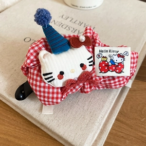 Red plaid fabric hair clip featuring a plush Hello Kitty character with a party hat