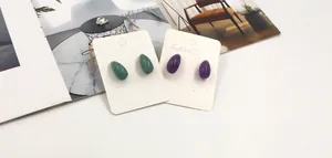 Detailed view of teardrop natural amethyst and amazonite stud earrings on jewelry cards