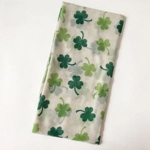 Detail view of voile scarf with green shamrock prints for Saint Patrick's Day theme
