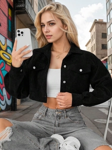 Detail of a black corduroy cropped jacket for women in a street style fashion look
