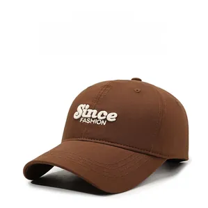 Detailed close-up of premium brown cotton twill fabric and white 3D letter embroidery