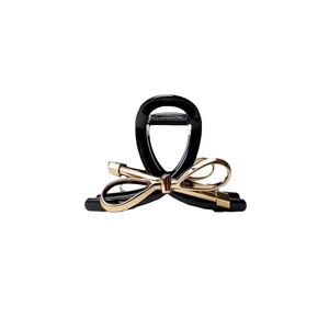 Glossy black hair claw clip featuring a metallic champagne gold bow decoration