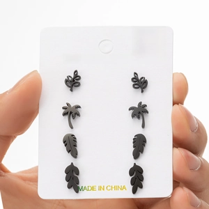 Black stainless steel leaf and palm tree stud earring set shown on display card