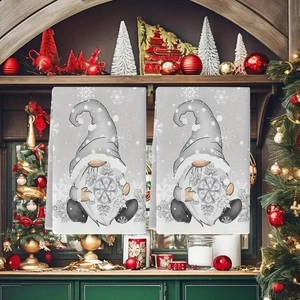 Christmas kitchen towels with festive gnomes hanging on a fireplace mantel