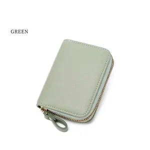 Close-up of green litchi texture leather RFID wallet with gold metal zipper detail