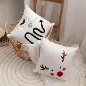 Set of two decorative Christmas pillows featuring reindeer and XMAS embroidery for home decor