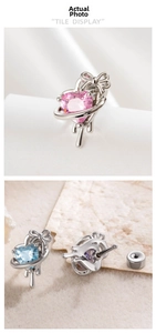 Macro view of heart-shaped zircon planet earrings with bow and screw back closure