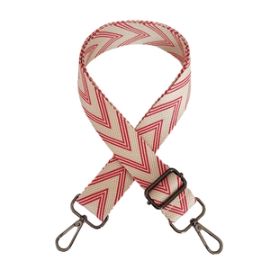 Detail of red and white herringbone woven strap with antique bronze metal clasps