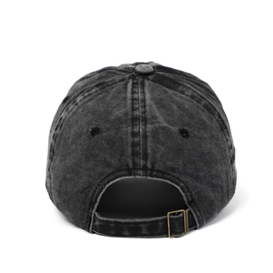 Detail view of washed denim baseball cap with vintage metal buckle and adjustable strap