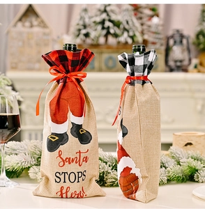 Linen Christmas wine bottle cover with red plaid pattern and Santa Stops Here text