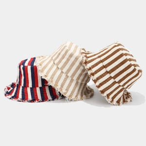 Three striped bucket hats with frayed edges in red, beige, and brown stripe patterns
