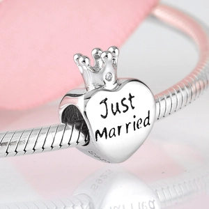 Macro view of S925 sterling silver Just Married heart charm with crown and zircon