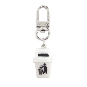Detail shot of mini white plastic trash bin keychain with metal hook and recycling icon
