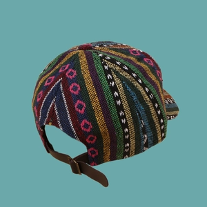 Detailed view of bohemian woven baseball cap with adjustable brown leather back strap