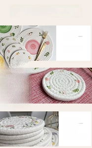 Detail view of woven cotton heat-resistant coasters with floral patterns and edge stitching