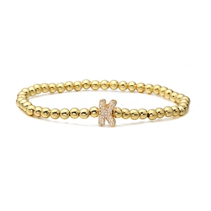 Close-up of golden beaded stretch bracelet featuring a micro-paved zircon letter K charm