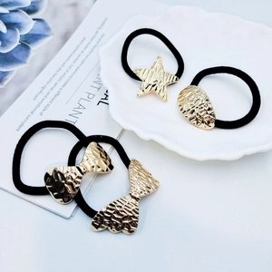 Set of 4 elegant black elastic hair ties with gold butterfly and star metal charms