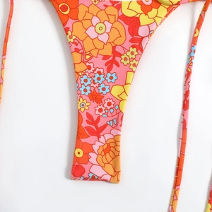 Close-up of vintage floral digital print on bikini fabric with pink and orange flowers