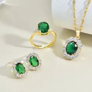 Detailed set of gold necklace, ring, and earrings with oval emerald zircon stones