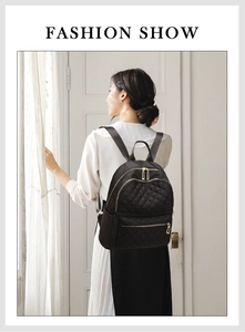 Detail of black quilted oxford backpack featuring golden zippers and adjustable straps